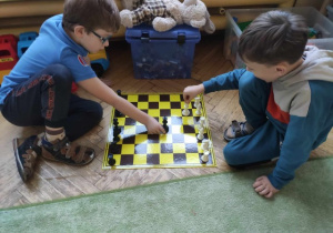 Chłopcy ustawiają szachy