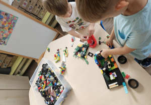 Chłopcy układają klocki lego.