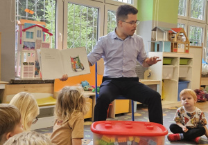 Dzieci słuchają czytanej książki.