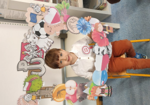 Chłopiec pozuje w ramce z symbolami narodowymi