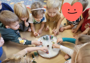 Dzieci bawią się sztucznym śniegiem, robią zimową dekorację