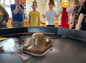Dzieci obserwują eksperyment- wybuchający wulakn.